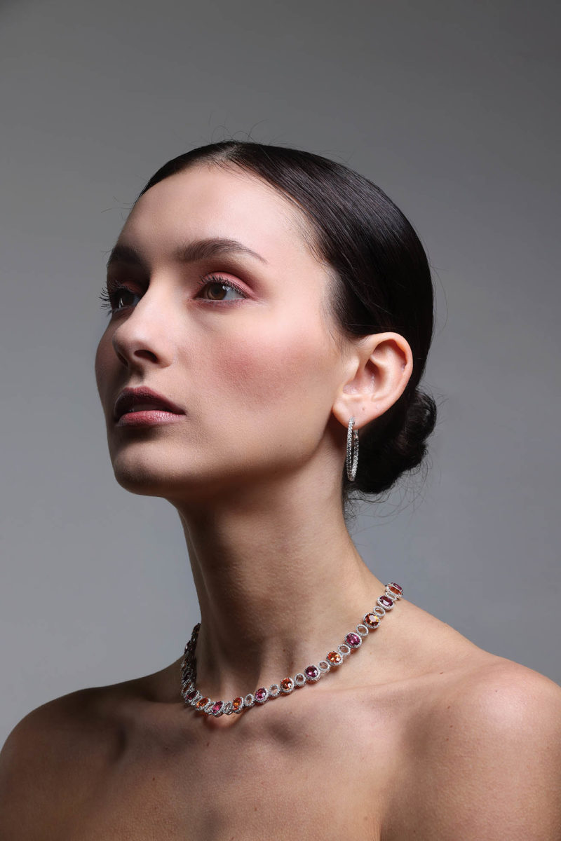 Diamond hoop earrings, $195; diamond, pink tourmaline, and spessartine garnet necklace, $47,700. Both from Hale’s Jewelers.