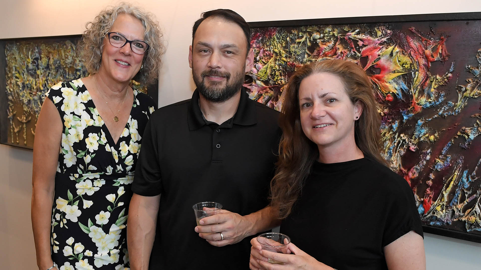 Melissa Sturgis, left, and Jeff and Anne Moore of No. 3 Pottery, enjoy the evening. The Simpsonville Arts Center presented the Ed Cascone Art Exhibition