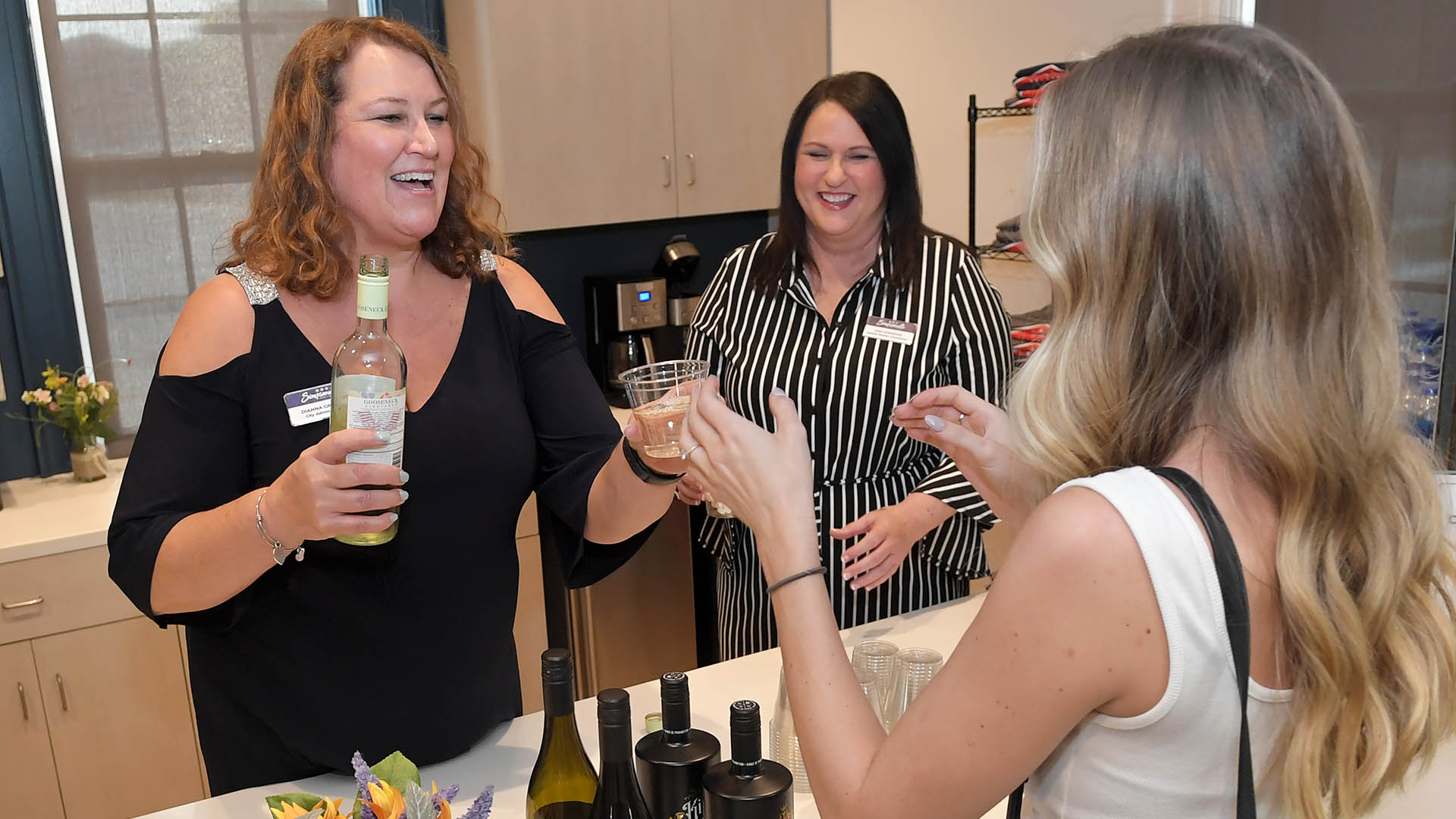 Dianna Gracely, Lisa Everidge serve wine to Anna Mitchum. The Simpsonville Arts Center presented the Ed Cascone Art Exhibition